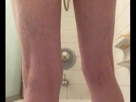 Skinny guy shaving in shower